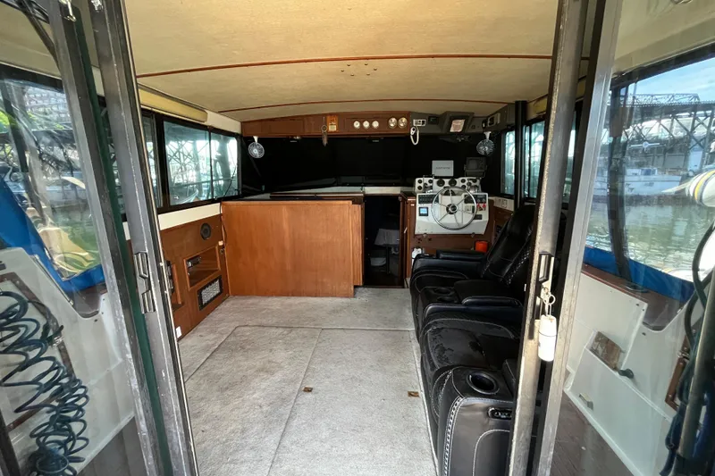 Slide: The Image of Interior of a 1976 Fiberform 34 boat with steering wheel and seating area. - 8