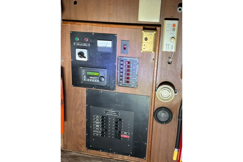 Slide: The Image of Control panel of a 1976 Fiberform 34 boat with various switches and gauges. - 9