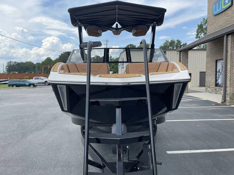 Slide: The Image of 2026 Nautique G23 boat on trailer, front view in parking lot. - 13