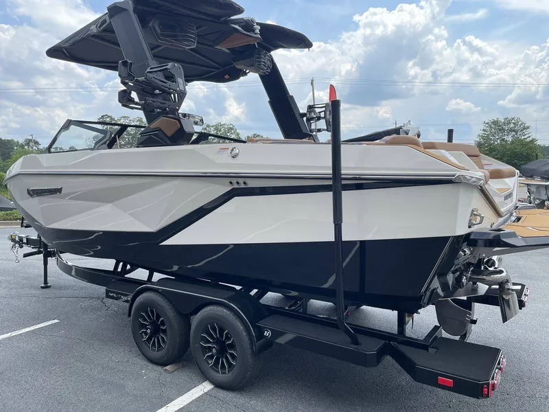 Slide: The Image of 2026 Nautique G23 boat on trailer, side view. - 35