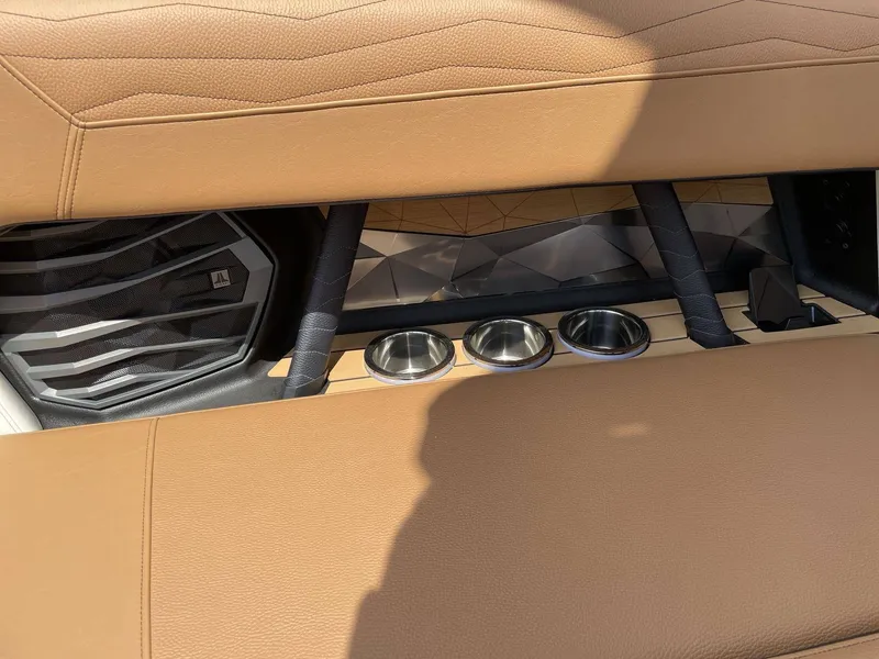 Slide: The Image of Interior of 2026 Nautique G23 with brown upholstery and cup holders. - 37