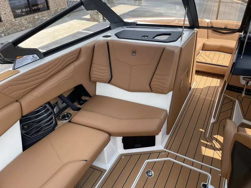 Slide: The Image of Interior of 2026 Nautique G23 with brown leather seating. - 44