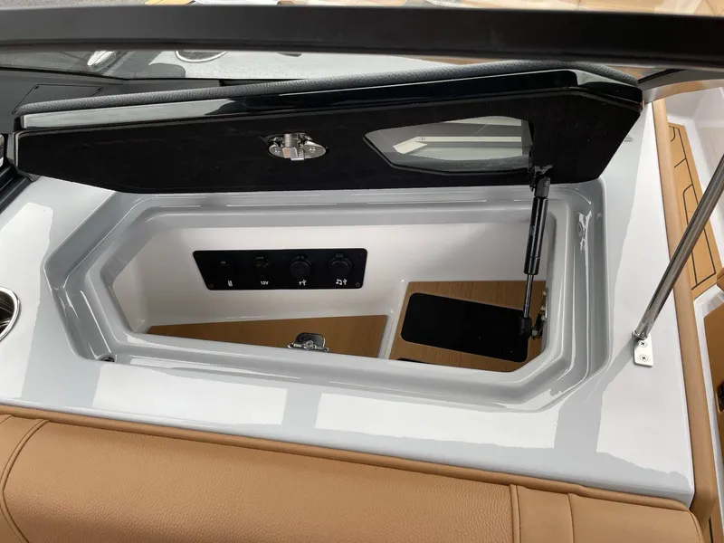 Slide: The Image of Interior view of 2026 Nautique G25 boat storage compartment. - 15