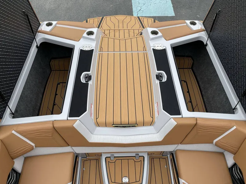 Slide: The Image of Interior of 2026 Nautique G25 with storage and seating. - 16