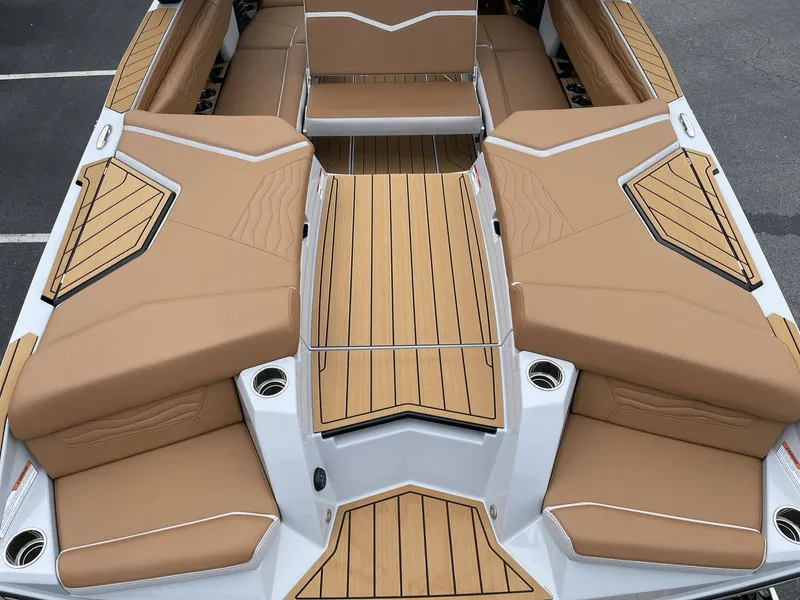 Slide: The Image of Interior of 2026 Nautique G25 with brown upholstery and wood flooring. - 22
