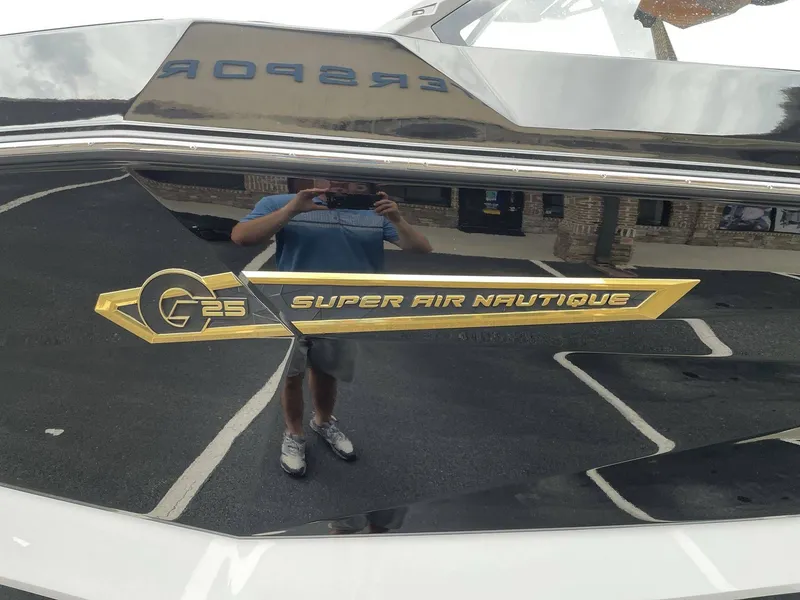 Slide: The Image of 2026 Nautique G25 Super Air boat logo close-up. - 26