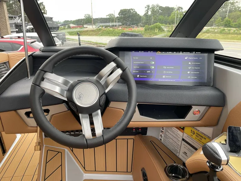 Slide: The Image of 2026 Nautique G25 interior with modern steering wheel and touchscreen display. - 29