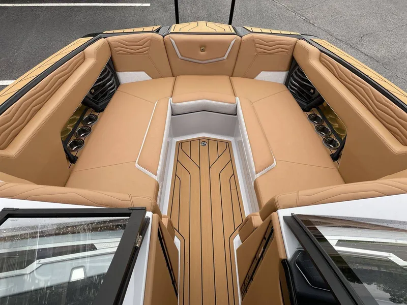 Slide: The Image of Interior of 2026 Nautique G25 with beige upholstery and cup holders. - 33