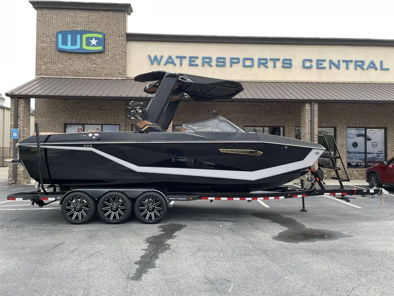 Slide: The Image of 2026 Nautique G25 boat parked in front of Watersports Central. - 4