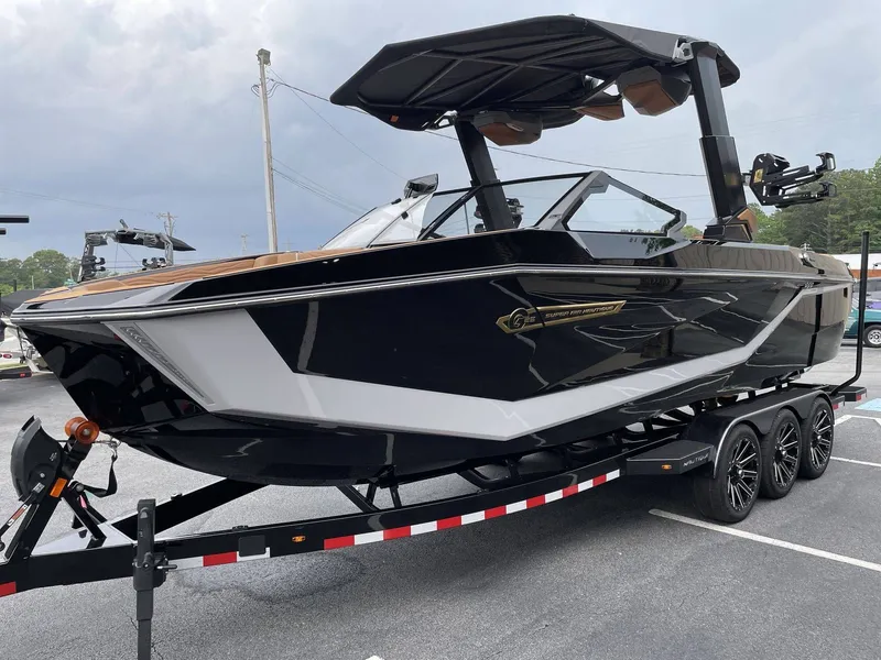 Slide: The Image of 2026 Nautique G25 boat on trailer, black design. - 41