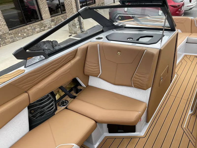 Slide: The Image of Interior of 2026 Nautique G25 with brown leather seating. - 42