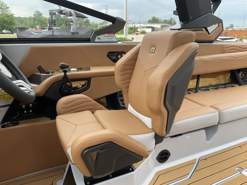 Slide: The Image of Interior of 2026 Nautique G25 featuring luxurious leather seating. - 43