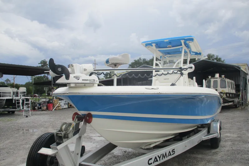 Slide: The Image of 2020 Caymas 28 HB boat on trailer, blue and white design, parked outdoors. - 3