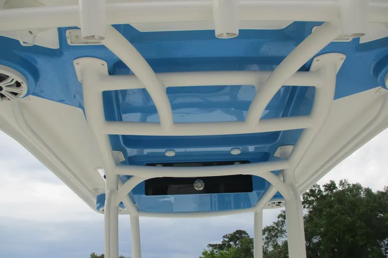 Slide: The Image of 2020 Caymas 28 HB boat T-top with blue accents and integrated speakers. - 5