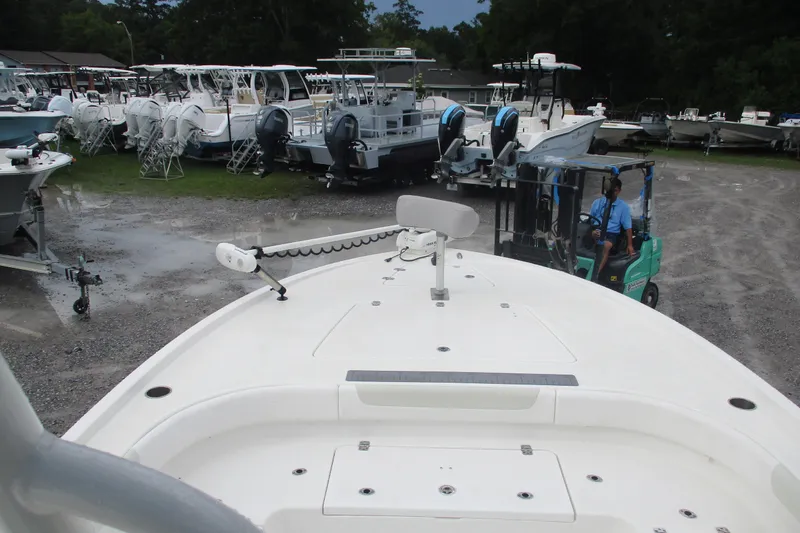 Slide: The Image of 2020 Caymas 28 HB boat on display at a dealership with other boats. - 6