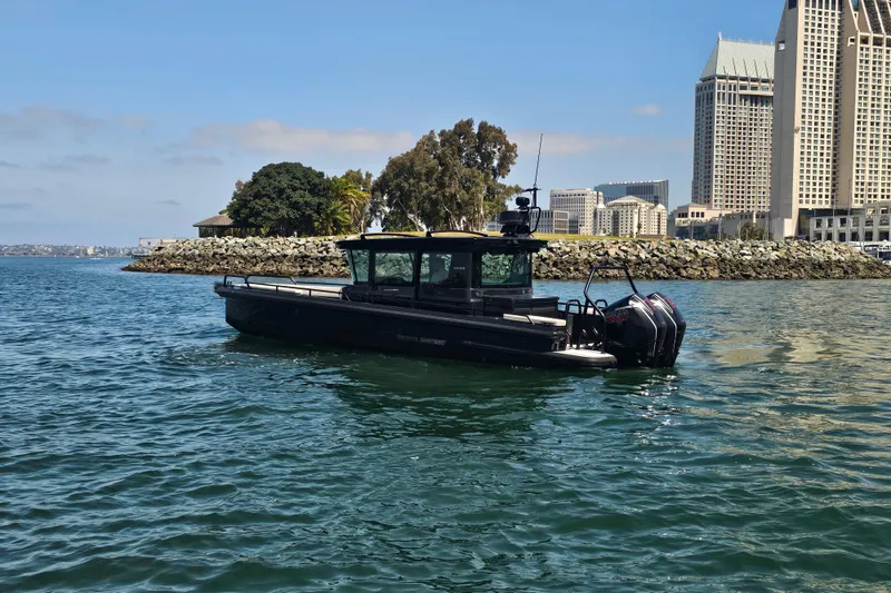 Slide: The Image of 2023 BRABUS Shadow 500 Black Ops boat on water near urban skyline. - 15