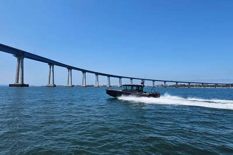 Slide: The Image of 2023 BRABUS Shadow 500 Black Ops speeding under a bridge on a sunny day. - 18