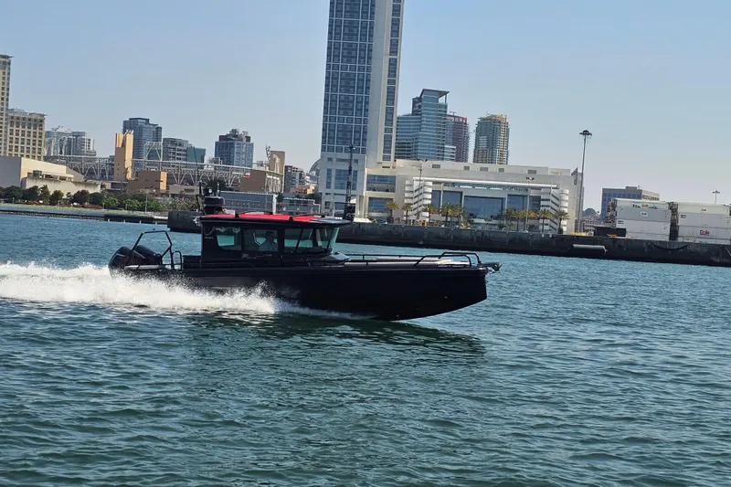 Slide: The Image of 2023 BRABUS Shadow 500 Black Ops cruising in urban waterfront setting. - 19