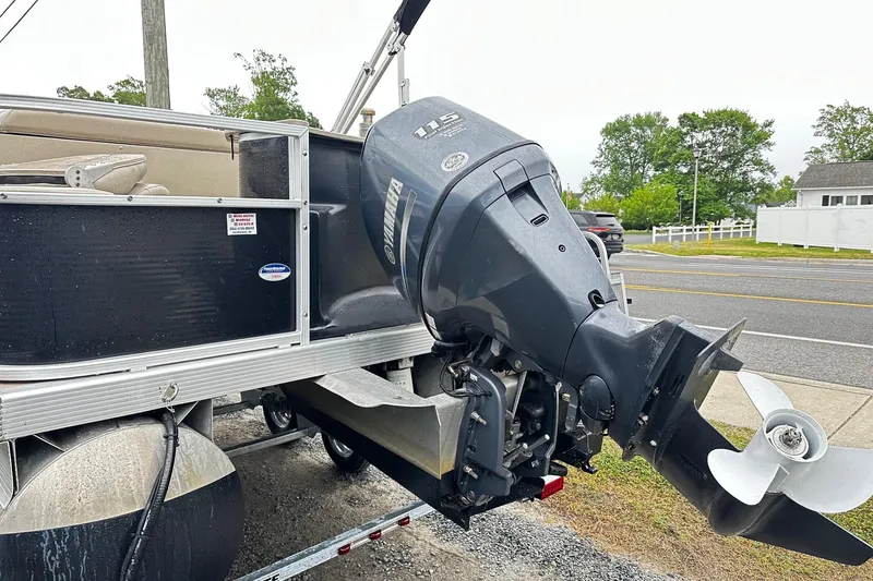 Slide: The Image of 2014 Bennington 2275SL Pontoon with Yamaha outboard motor, parked on a trailer. - 10
