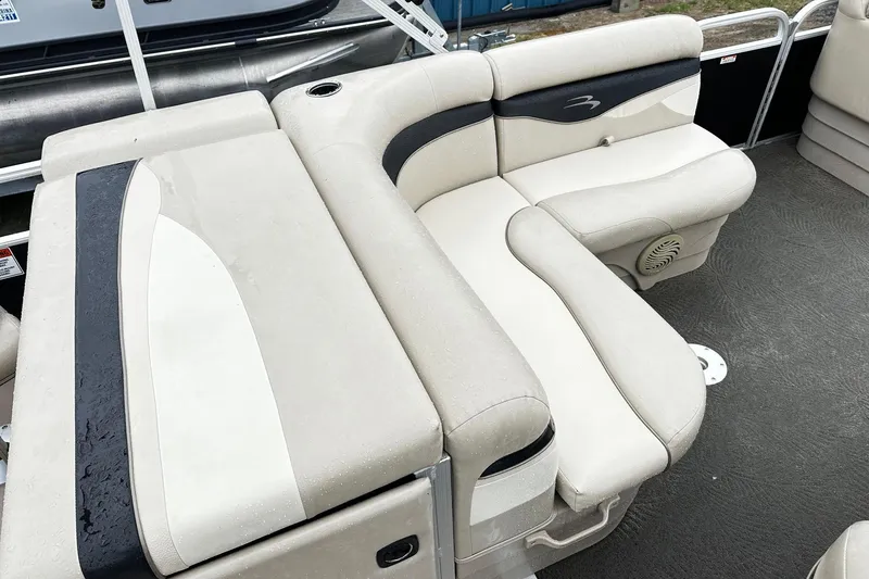 Slide: The Image of 2014 Bennington 2275SL Pontoon boat interior with beige and black seating. - 6