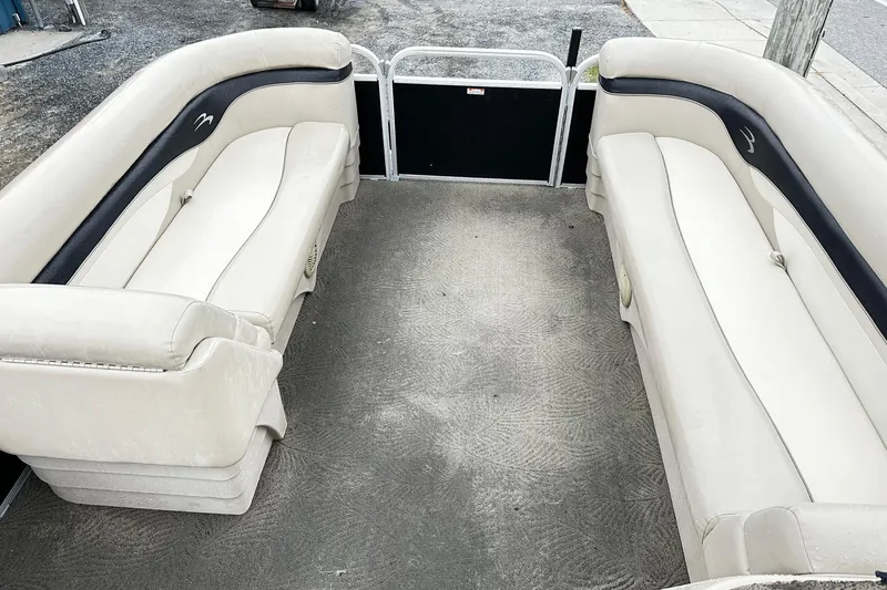 Slide: The Image of 2014 Bennington 2275SL Pontoon interior with beige seating and clean flooring. - 7