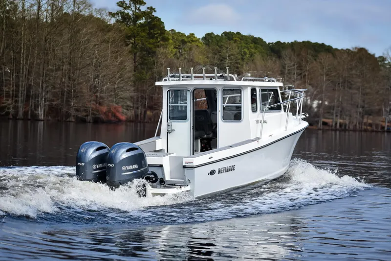 Slide: The Image of 2027 Defiance Admiral 250 EX boat cruising on a serene lake with twin Yamaha engines. - 2