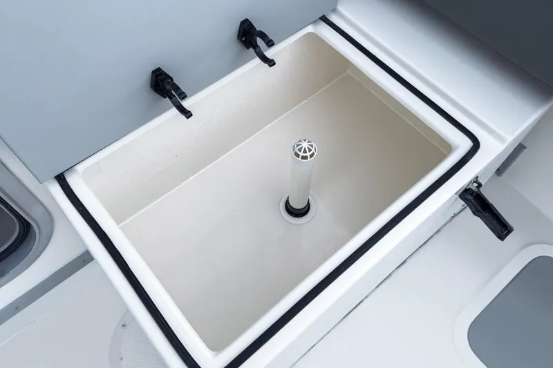 Slide: The Image of Livewell compartment on 2027 Defiance Admiral 250 EX boat, featuring secure latches and drainage system. - 7