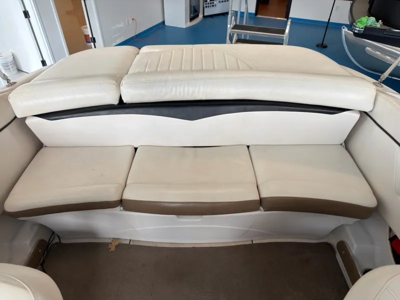 Slide: The Image of Interior of a 2008 Four Winns H210 boat with beige seating. - 11