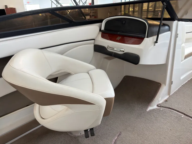 Slide: The Image of Interior of a 2008 Four Winns H210 boat with beige seating. - 15
