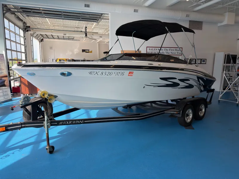 Slide: The Image of 2008 Four Winns H210 boat on trailer in showroom. - 3