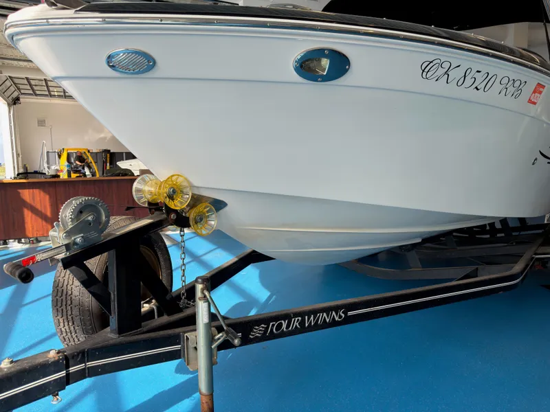 Slide: The Image of 2008 Four Winns H210 boat on trailer in garage. - 4