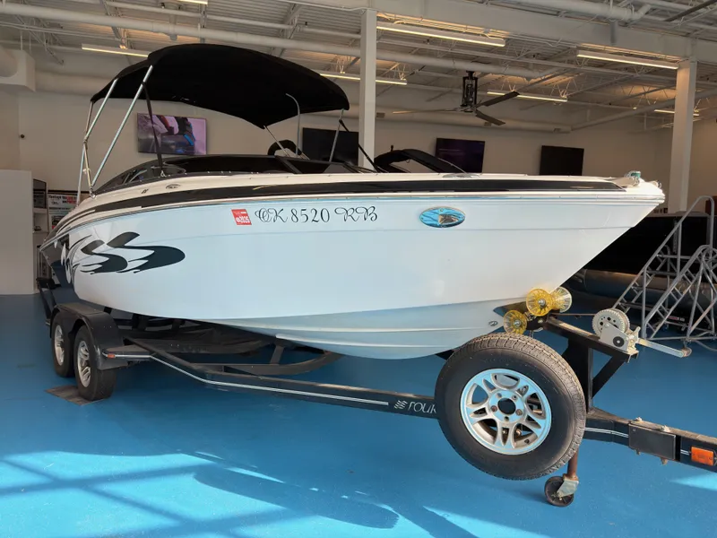 Slide: The Image of 2008 Four Winns H210 boat on trailer in showroom. - 5