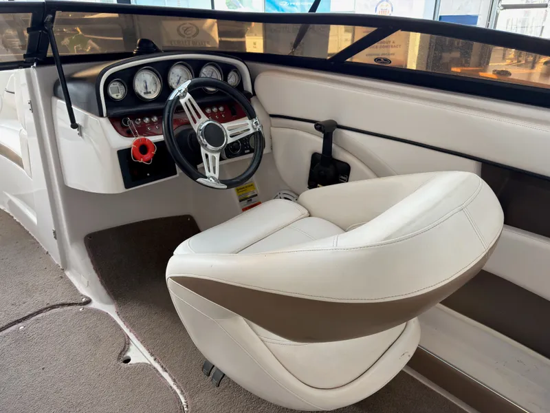 Slide: The Image of Interior of a 2008 Four Winns H210 boat with steering console. - 9