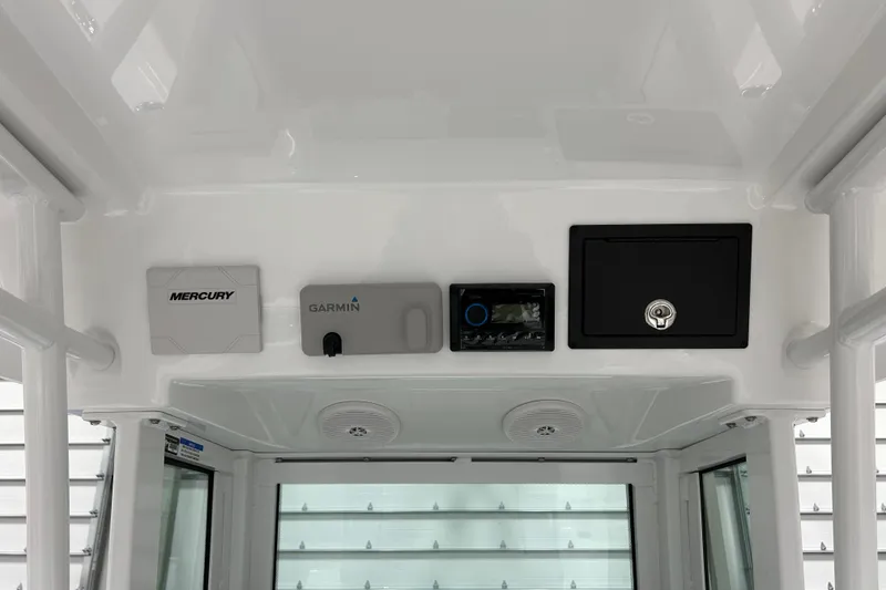 Slide: The Image of 2026 Wellcraft 243 Fisherman boat dashboard featuring Mercury and Garmin electronics. - 10