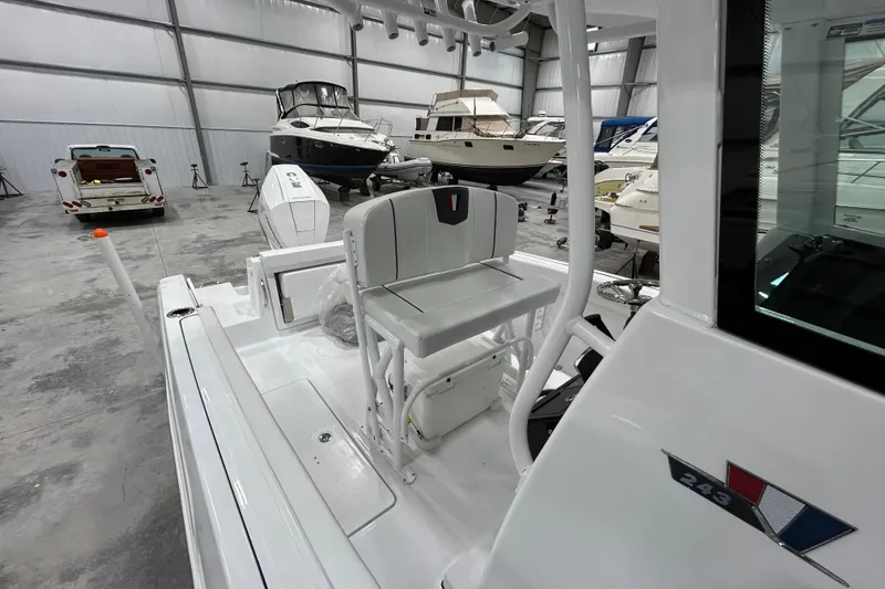 Slide: The Image of 2026 Wellcraft 243 Fisherman boat interior in a showroom with other boats. - 11