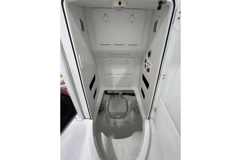 Slide: The Image of Interior view of 2026 Wellcraft 243 Fisherman boat's storage compartment. - 14