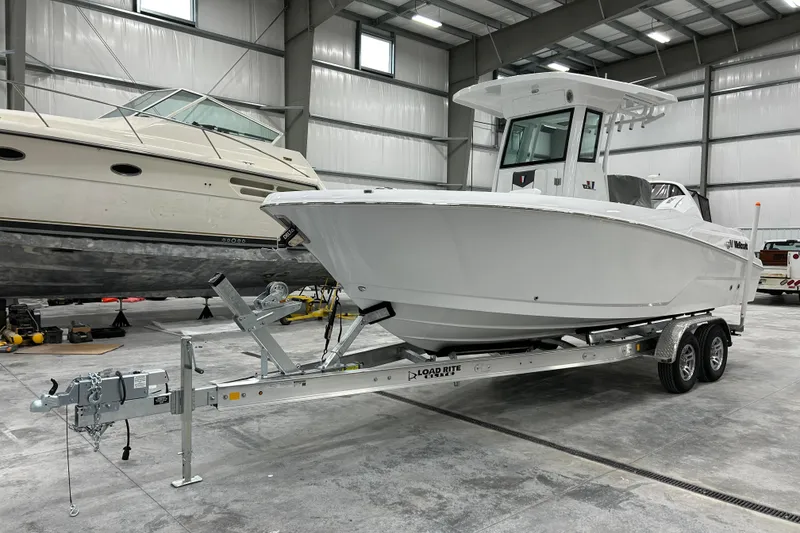 Slide: The Image of 2026 Wellcraft 243 Fisherman boat on trailer in indoor storage facility. - 3