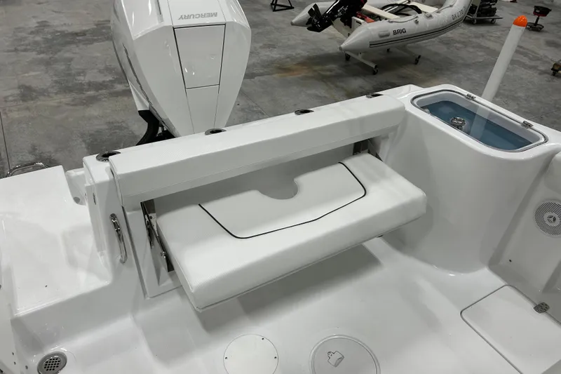 Slide: The Image of 2026 Wellcraft 243 Fisherman boat interior with foldable seat and Mercury engine. - 7