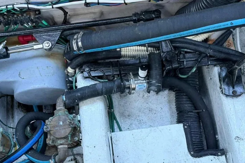 Slide: The Image of Engine compartment of a 2008 Sea Ray 380 Sundancer with visible hoses and wiring. - 15