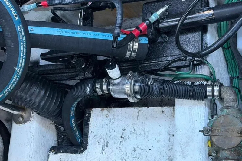 Slide: The Image of Engine compartment of a 2008 Sea Ray 380 Sundancer with visible hoses and fittings. - 17