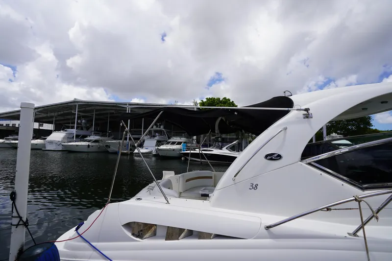 Slide: The Image of 2008 Sea Ray 380 Sundancer yacht docked at marina under cloudy sky. - 18