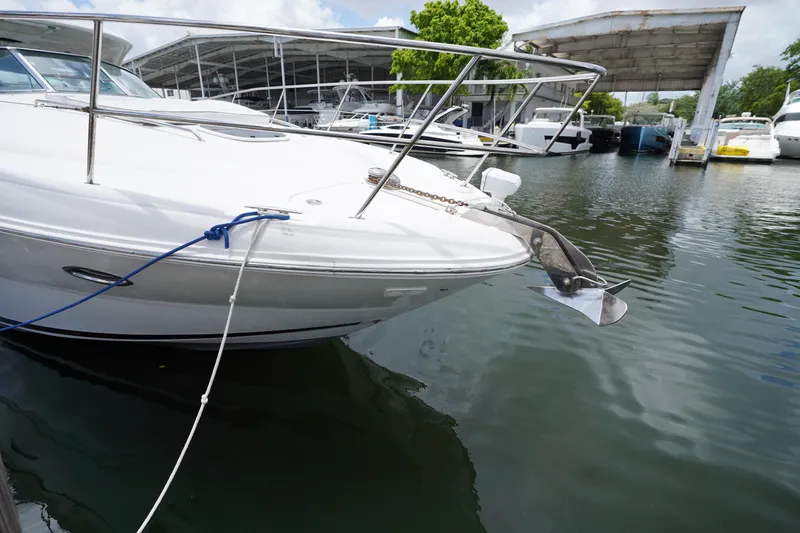 Slide: The Image of 2008 Sea Ray 380 Sundancer yacht docked at marina, featuring sleek white hull and anchor. - 6