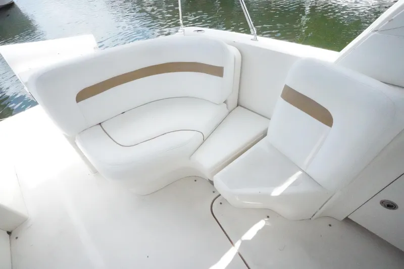 Slide: The Image of White seating area on 2008 Sea Ray 380 Sundancer boat, near water. - 9