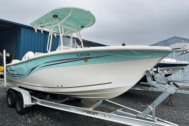 The Image of 2017 Sea Chaser 22 HFC boat on trailer, featuring sleek design and turquoise accents. - 0