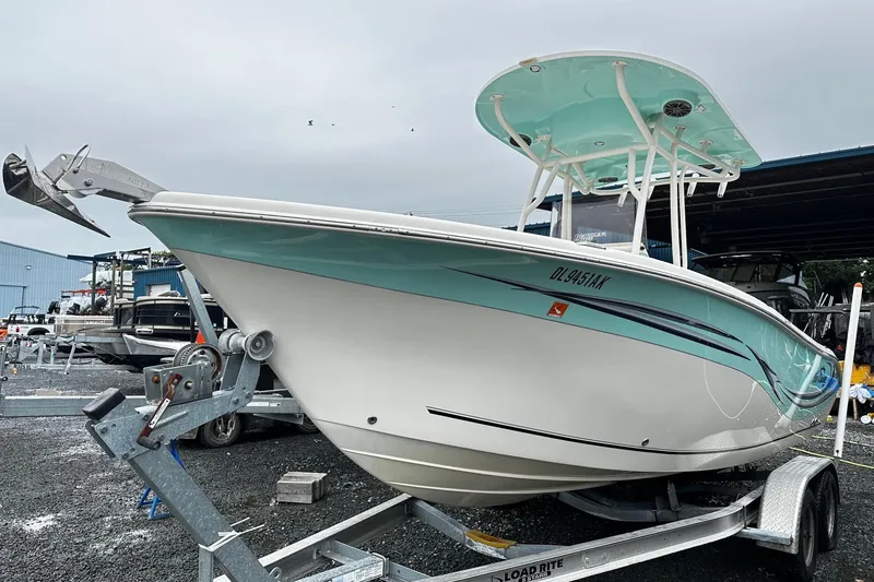 Slide: The Image of 2017 Sea Chaser 22 HFC boat on trailer, featuring a sleek design and turquoise accents. - 1
