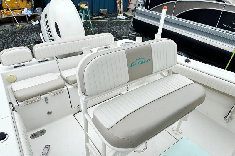 Slide: The Image of 2017 Sea Chaser 22 HFC boat interior with seating and Suzuki outboard motor. - 10