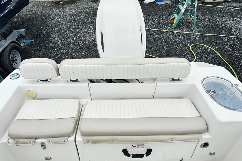 Slide: The Image of 2017 Sea Chaser 22 HFC boat interior with white cushioned seating and storage compartments. - 11