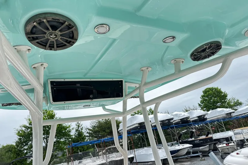 Slide: The Image of 2017 Sea Chaser 22 HFC boat interior with speakers and storage, docked near other boats. - 6