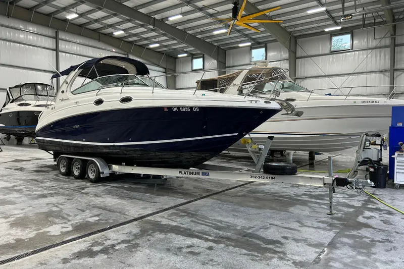 The Image of 2004 Sea Ray Sundancer 280 boat on trailer in indoor storage facility. - 0