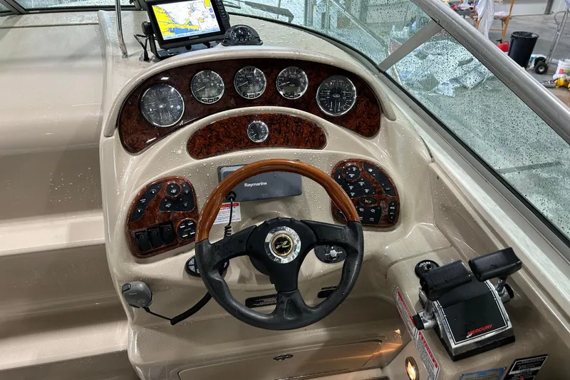 Slide: The Image of 2004 Sea Ray Sundancer 280 helm with wood accents and navigation equipment. - 10